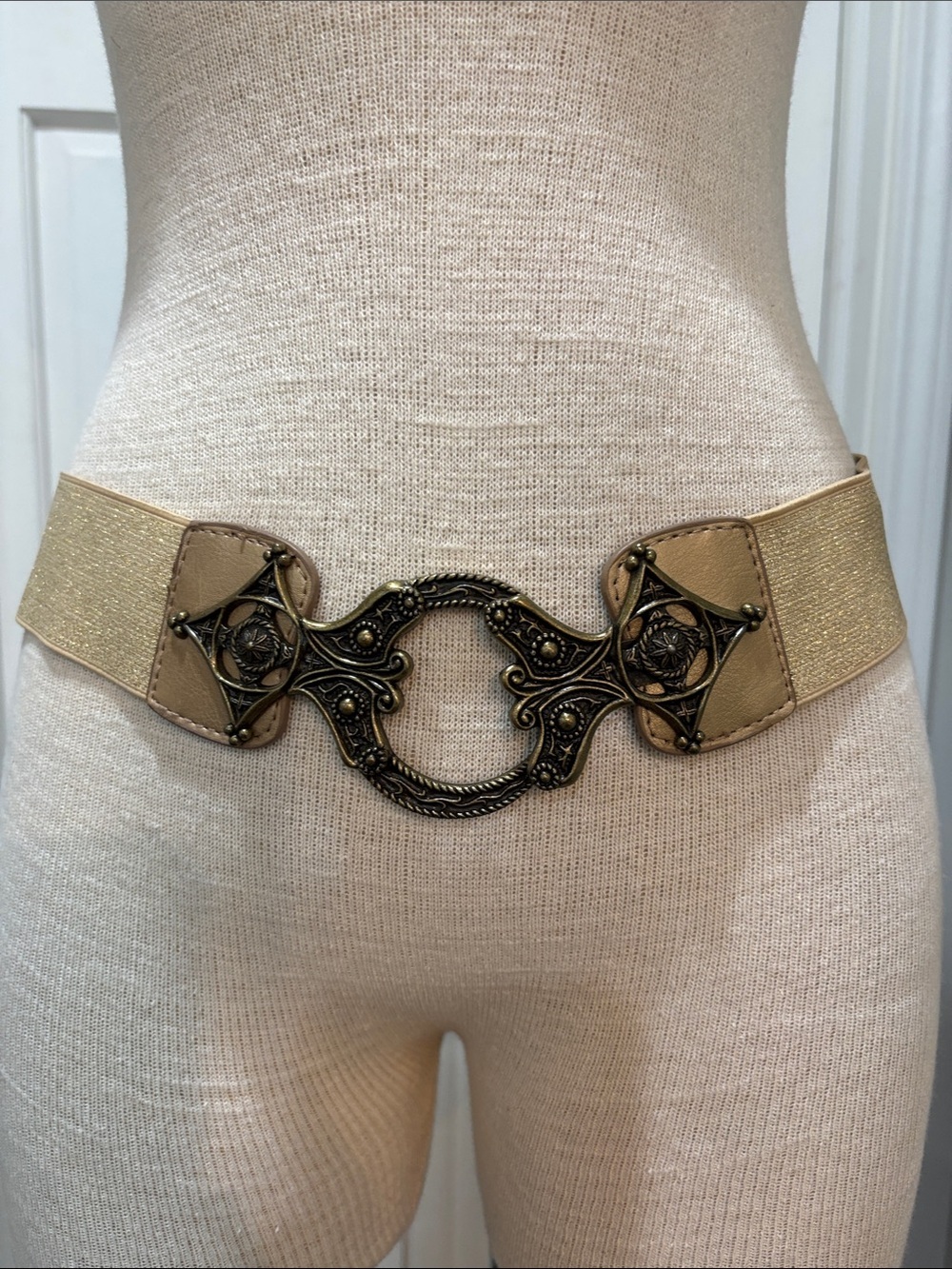 Metallic gold stretchy belt with ornate brass look buckle